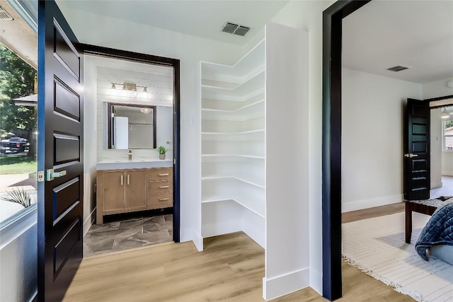 2402 Broken Oak Dr, Austin, TX 78745 - bathroom featuring vanity and wood finished floors