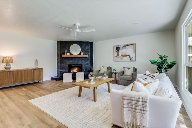 2402 Broken Oak Dr, Austin, TX 78745 - living room with light wood-type flooring, ceiling fan, and a fireplace