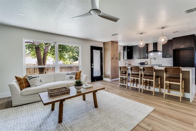 2402 Broken Oak Dr, Austin, TX 78745 - living area with a ceiling fan and light wood-style flooring