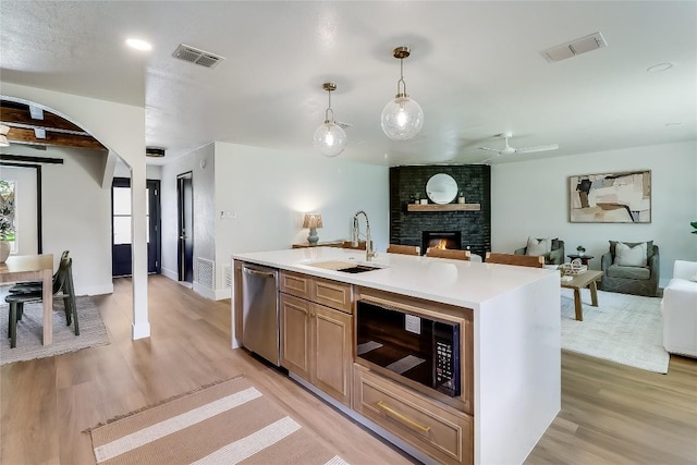 2402 Broken Oak Dr, Austin, TX 78745 - kitchen with built in microwave, dishwasher, open floor plan, and light wood-style flooring