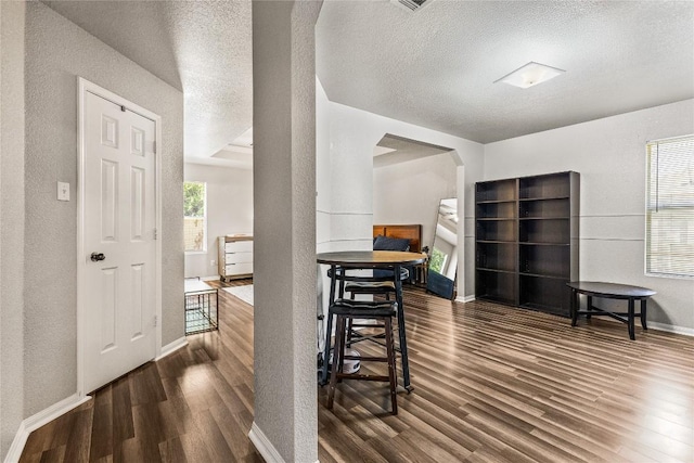 5302 Oster Dr, Killeen, TX 76542 - foyer entrance featuring wood finished floors, arched walkways, a textured wall, and a textured ceiling