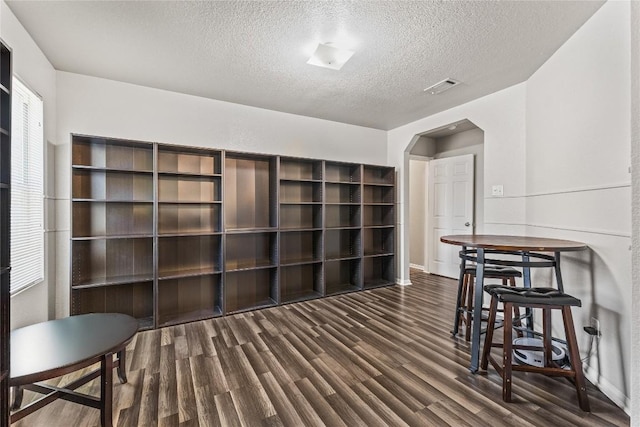 5302 Oster Dr, Killeen, TX 76542 - living area featuring wood finished floors, a textured ceiling, and arched walkways