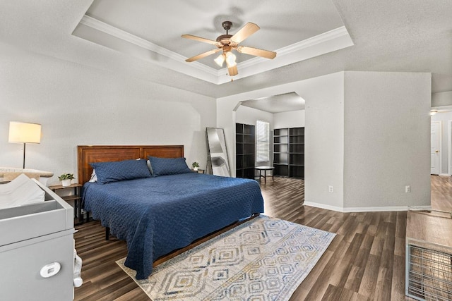 5302 Oster Dr, Killeen, TX 76542 - bedroom featuring a raised ceiling, wood finished floors, crown molding, ceiling fan, and arched walkways