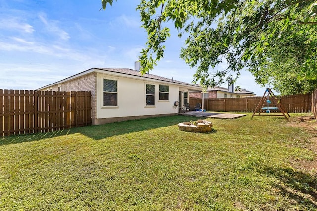 5302 Oster Dr, Killeen, TX 76542 - back of property with a fenced backyard, an outdoor fire pit, a patio area, brick siding, and a playground