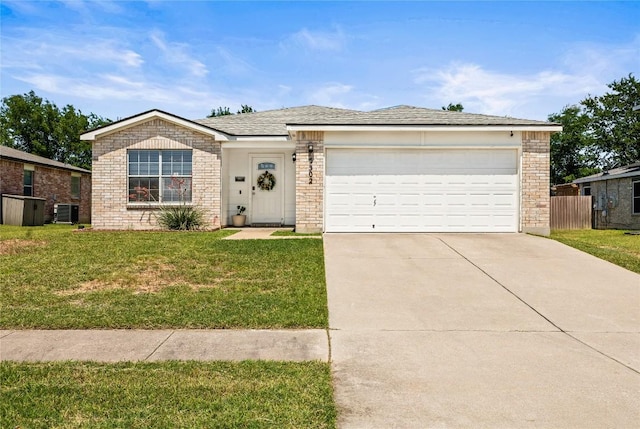 5302 Oster Dr, Killeen, TX 76542 - ranch-style home with concrete driveway, a front yard, a garage, and brick siding