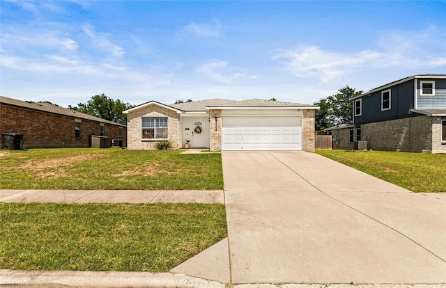 5302 Oster Dr, Killeen, TX 76542 - view of front of house featuring concrete driveway, an attached garage, brick siding, and a front yard