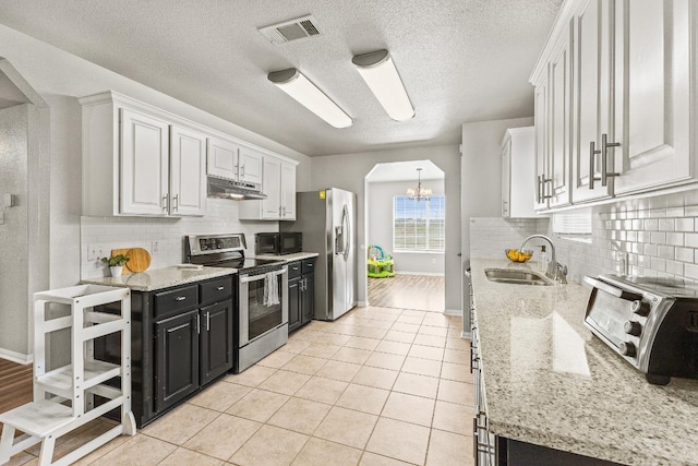 5302 Oster Dr, Killeen, TX 76542 - kitchen featuring appliances with stainless steel finishes, under cabinet range hood, a chandelier, dark cabinets, and white cabinets
