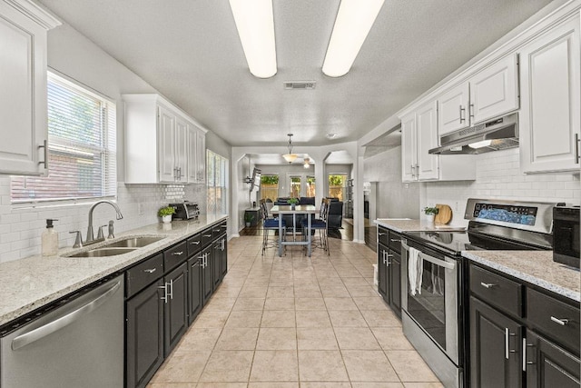 5302 Oster Dr, Killeen, TX 76542 - kitchen with appliances with stainless steel finishes, under cabinet range hood, white cabinetry, and dark cabinets
