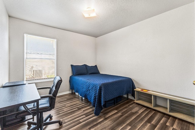 5302 Oster Dr, Killeen, TX 76542 - bedroom featuring dark wood finished floors, a desk, and a textured ceiling