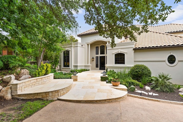 8634 Navidad Dr, Austin, TX 78735 - view of front of home with stucco siding and a tile roof