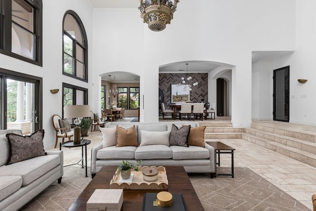 8634 Navidad Dr, Austin, TX 78735 - living area with arched walkways, a towering ceiling, and a chandelier