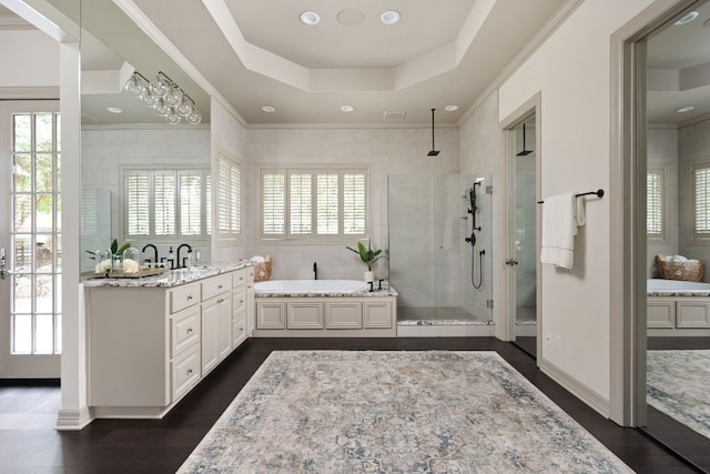 8634 Navidad Dr, Austin, TX 78735 - full bathroom featuring a shower stall, vanity, a garden tub, a tray ceiling, and wood finished floors