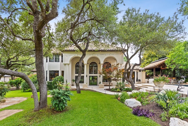 8634 Navidad Dr, Austin, TX 78735 - rear view of property featuring stucco siding, a lawn, and a patio