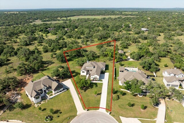 230 Wilderness Cv, Driftwood, TX 78619 - aerial perspective of suburban area with a forest and property boundaries highlighted