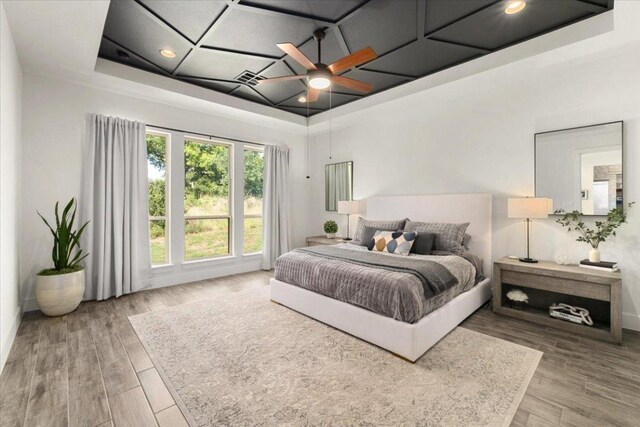 230 Wilderness Cv, Driftwood, TX 78619 - bedroom featuring coffered ceiling, wood finished floors, recessed lighting, and a ceiling fan