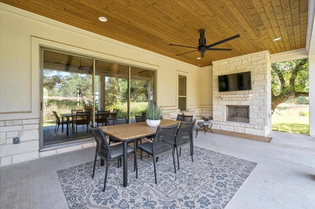 230 Wilderness Cv, Driftwood, TX 78619 - view of patio featuring an outdoor stone fireplace, outdoor dining area, and ceiling fan