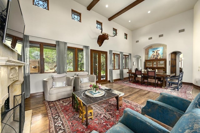 3816 Pappys Way, Austin, TX 78730 - living area with arched walkways, a high ceiling, wood finished floors, beam ceiling, and recessed lighting