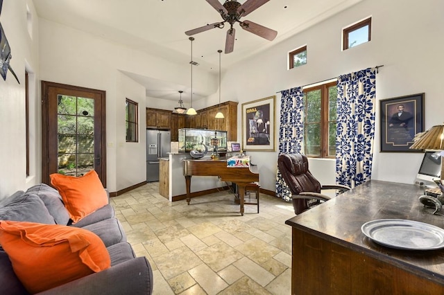 3816 Pappys Way, Austin, TX 78730 - living room with a high ceiling, plenty of natural light, stone tile flooring, and a ceiling fan