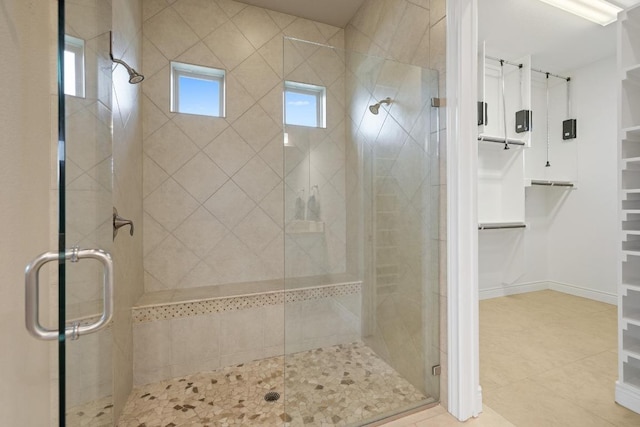108 Marbella Way, Georgetown, TX 78633 - full bathroom with a shower stall, a walk in closet, and tile patterned flooring