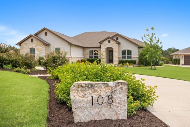 108 Marbella Way, Georgetown, TX 78633 - french country inspired facade featuring stone siding, a front yard, and stucco siding