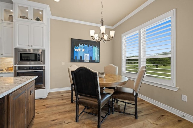 108 Marbella Way, Georgetown, TX 78633 - dining room featuring a chandelier, ornamental molding, and light wood-style flooring