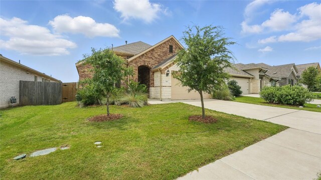 687 Oleander Loop, Buda, TX 78610 - view of front of home featuring driveway, a garage, and brick siding
