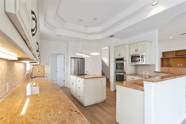 403 Hazeltine Dr, Lakeway, TX 78734 - kitchen with appliances with stainless steel finishes, light stone countertops, decorative backsplash, recessed lighting, and hanging light fixtures
