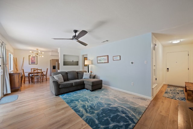 2801 Cornish Cir, Austin, TX 78745 - living area featuring a chandelier, light wood finished floors, and a ceiling fan