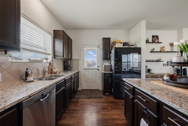 7304 Fall Ray Dr, Del Valle, TX 78617 - kitchen with stainless steel dishwasher, freestanding refrigerator, dark wood-style floors, light stone counters, and tasteful backsplash