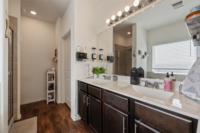 7304 Fall Ray Dr, Del Valle, TX 78617 - bathroom with a stall shower, wood finished floors, double vanity, and recessed lighting