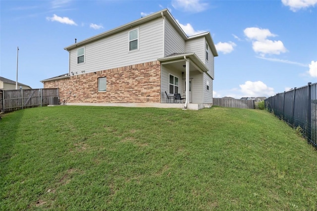 7304 Fall Ray Dr, Del Valle, TX 78617 - rear view of property featuring brick siding, a fenced backyard, and a patio