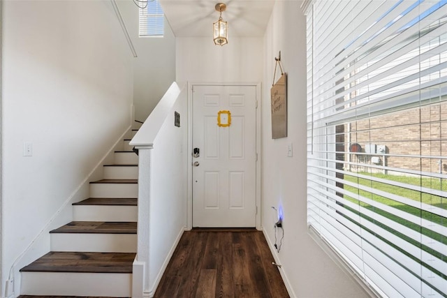 7304 Fall Ray Dr, Del Valle, TX 78617 - entrance foyer with dark wood-style floors, stairway, and a high ceiling