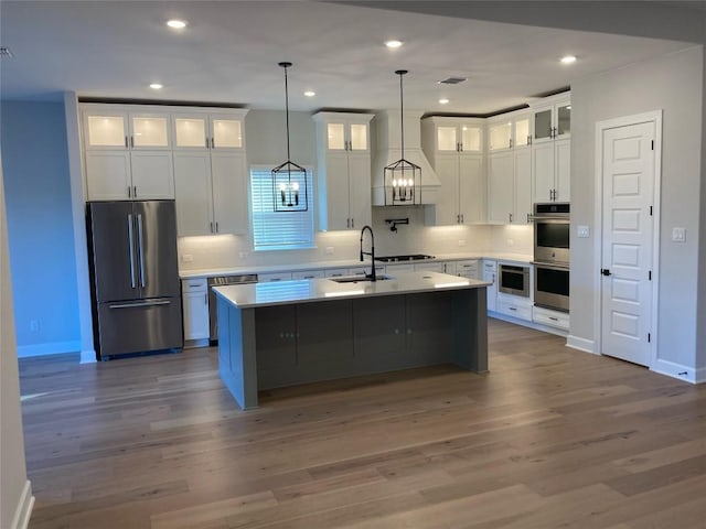 148 Cherry Sage Ct, Dripping Springs, TX 78620 - kitchen featuring stainless steel appliances, a kitchen island with sink, decorative backsplash, recessed lighting, and white cabinetry