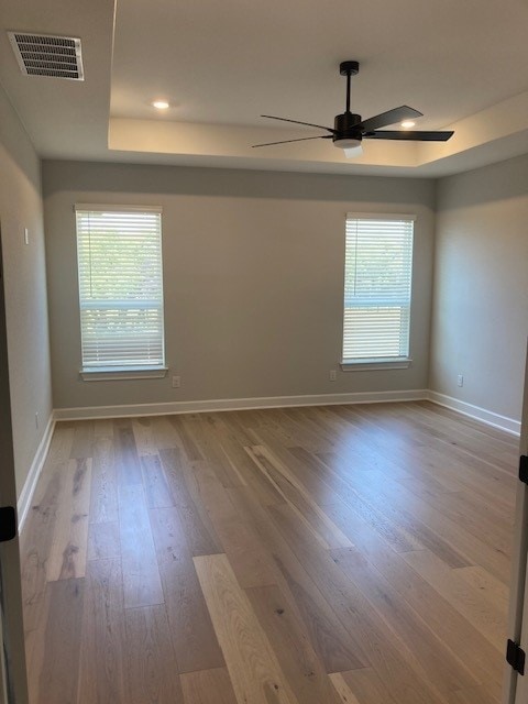120 Prairie Clover Dr, Dripping Springs, TX 78620 - spare room with wood finished floors, a tray ceiling, a ceiling fan, healthy amount of natural light, and recessed lighting