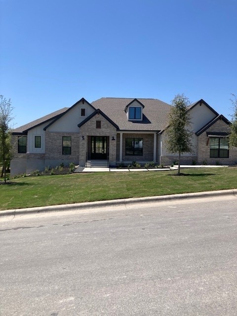 120 Prairie Clover Dr, Dripping Springs, TX 78620 - view of front facade featuring a front lawn and stone siding