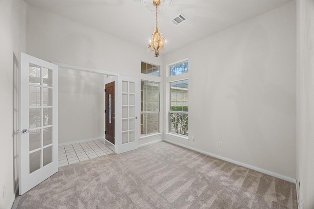 706 Cornell Dr, Pflugerville, TX 78660 - tiled spare room with french doors, carpet floors, and a chandelier