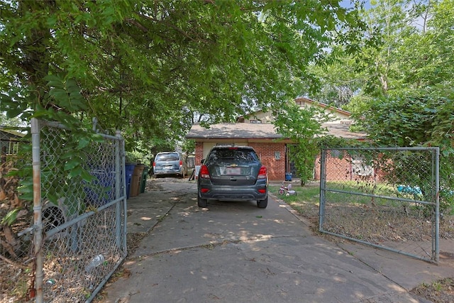 6110 Calmar Cv, Austin, TX 78721 - view of front of property with driveway, brick siding, and a gate