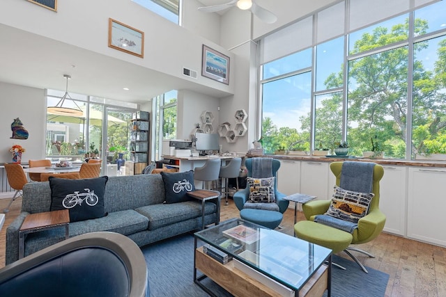 1600 Barton Springs Rd Unit 5406, Austin, TX 78704 - living area with light wood finished floors, ceiling fan, and a high ceiling