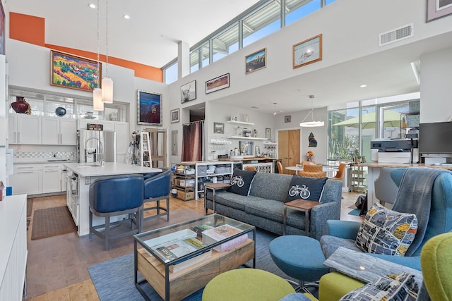 1600 Barton Springs Rd Unit 5406, Austin, TX 78704 - living room with a high ceiling, plenty of natural light, wood finished floors, and recessed lighting