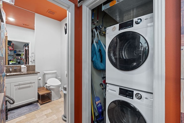 1600 Barton Springs Rd Unit 5406, Austin, TX 78704 - washroom featuring stacked washer / drying machine and stone finish floors