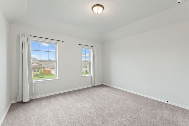 627 Cold River Run, Kyle, TX 78640 - carpeted empty room featuring baseboards and vaulted ceiling