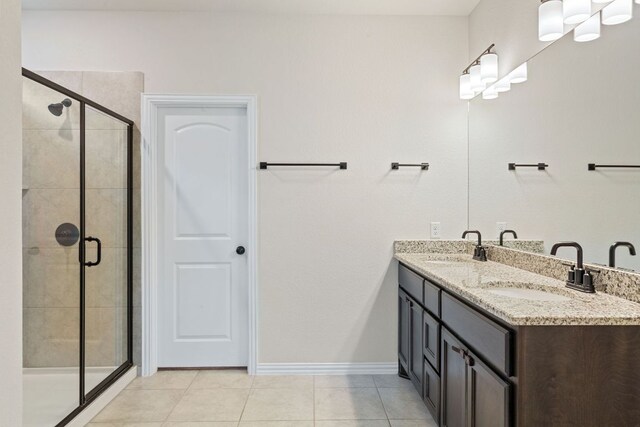627 Cold River Run, Kyle, TX 78640 - full bath featuring double vanity, a stall shower, and tile patterned flooring