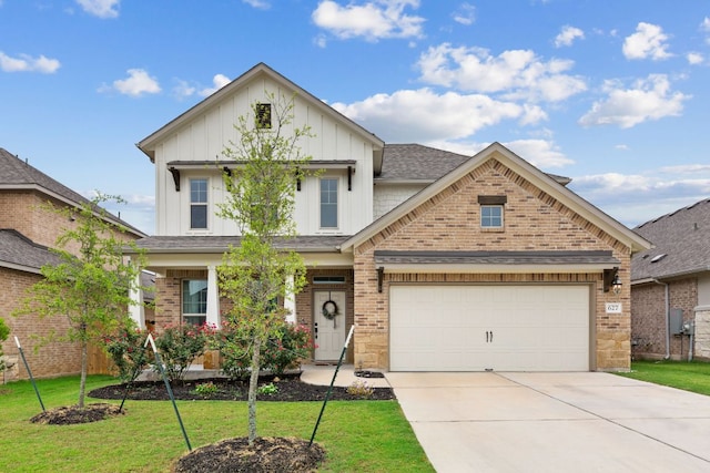 627 Cold River Run, Kyle, TX 78640 - view of front of house featuring board and batten siding, driveway, brick siding, a front lawn, and an attached garage