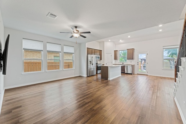 627 Cold River Run, Kyle, TX 78640 - unfurnished living room with ceiling fan, dark wood-type flooring, and recessed lighting