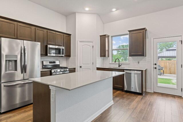 627 Cold River Run, Kyle, TX 78640 - kitchen with appliances with stainless steel finishes, dark brown cabinets, light countertops, and recessed lighting
