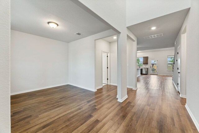 627 Cold River Run, Kyle, TX 78640 - unfurnished living room with dark wood finished floors and baseboards
