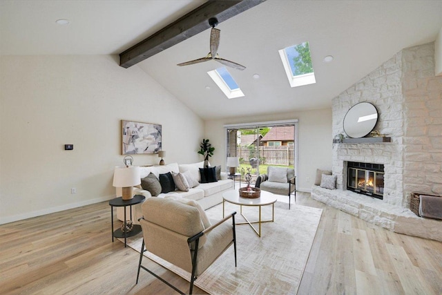 7906 Swindon Ln, Austin, TX 78745 - living room with a skylight, beamed ceiling, light wood finished floors, a stone fireplace, and high vaulted ceiling