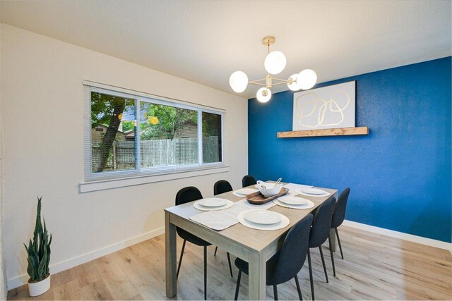 7906 Swindon Ln, Austin, TX 78745 - dining area featuring light wood-style flooring and a chandelier