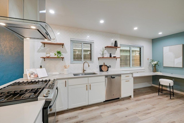7906 Swindon Ln, Austin, TX 78745 - kitchen featuring appliances with stainless steel finishes, open shelves, range hood, light wood finished floors, and white cabinetry