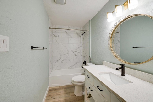 7906 Swindon Ln, Austin, TX 78745 - bathroom with vanity, wood finished floors, bathing tub / shower combination, and a textured wall